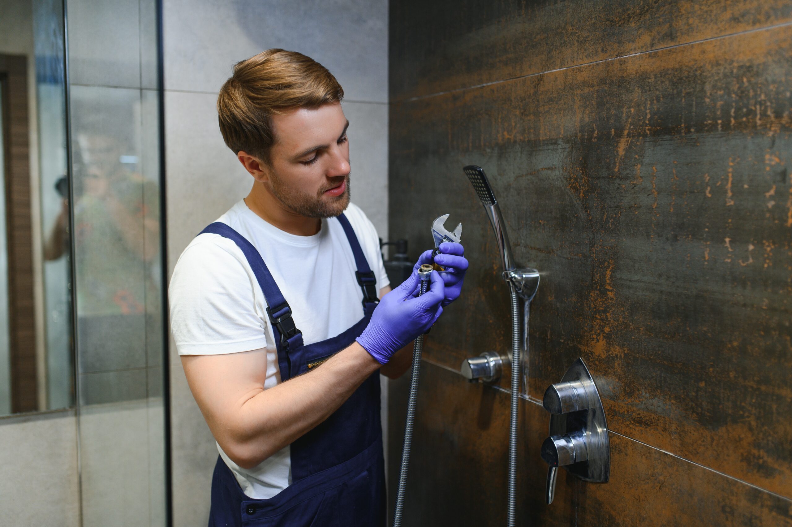 professional handyman working in shower booth indo 2025 03 15 10 00 08 utc 1 scaled