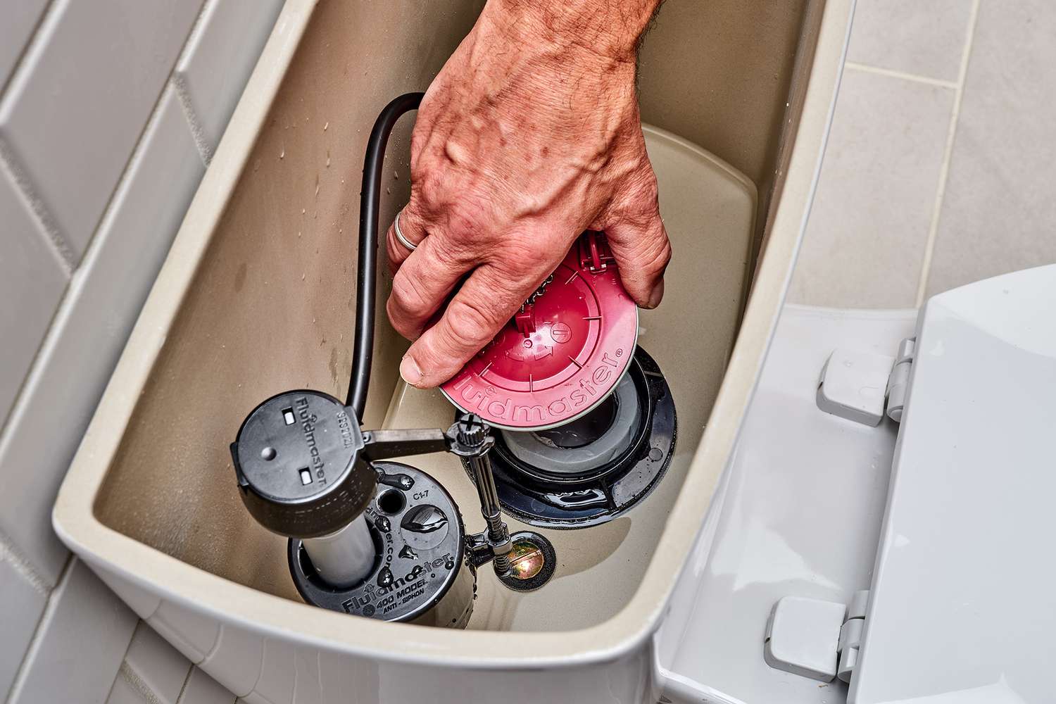 repairing leaky toilet tank flush valve 1824907 hero 4190aa7ed0a54c7580546bcb3c7e3186 1